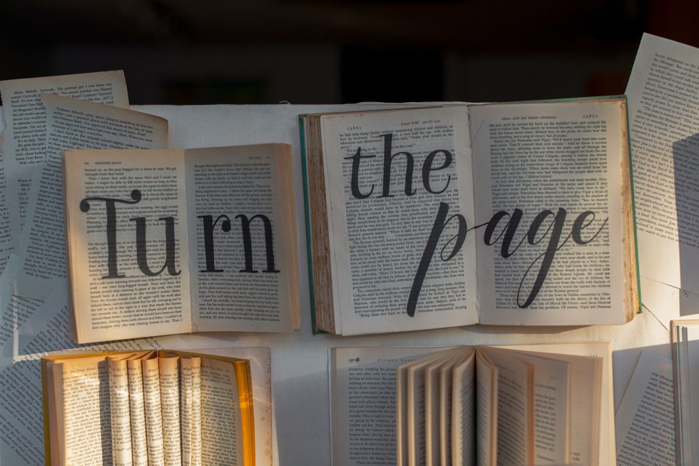 Books background with "turn the page" statement