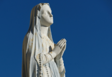 An image of a statue of Mother Mary. She is looking up while she stands with her palms pressed together, she looks peaceful and full of gratitude. This is surrounded by two mirrored photos of a statue of Mother Mary but her expression is different, her head is bowed, she looks trusting, and her palms are open as she is ready to receive her blessings